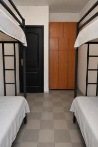 a bedroom with two bunk beds and a black door at Хостел Арабея in Vinnytsya