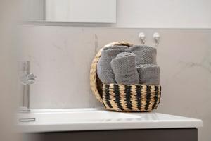 a basket of towels sitting on top of a sink at Casa Sole Porlezza in Porlezza +13 photos