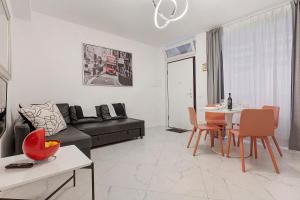 a living room with a couch and a table at Casa Sole Porlezza in Porlezza