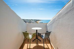 a small balcony with a table and two chairs at Vila Sao Vicente Boutique (Adults Only) in Albufeira