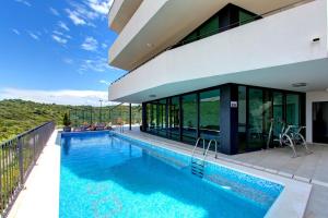 a villa with a swimming pool and a house at Green Hill Penthouse apartment in Korčula