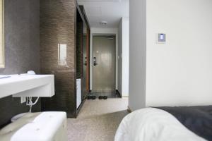 Postel nebo postele na pokoji v ubytování Eins Hotel