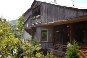a house with a porch and a balcony at ARTSIV Guesthouse in Dilijan