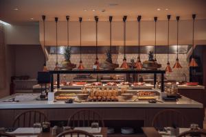 a buffet line of food in a restaurant at Planos Deluxe in Zakynthos