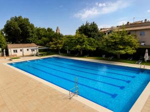 a large blue swimming pool in a building at El Somni de Paqui Apartamentos Boutique Only Adults in Alfafara