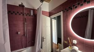 a bathroom with a tub and a sink and a mirror at Adagio Umbro in Sustrico Di Spoleto +59 photos