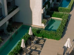 an overhead view of a swimming pool with chairs and umbrellas at Planos Deluxe in Zakynthos +46 photos