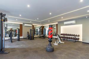 a gym with a bunch of equipment in a room at PLM hotel Prima Life Makadi in Hurghada