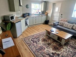 a living room with a couch and a table at The Stables Annexe in Patrington