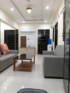 a living room with two couches and a coffee table at Hotel 7 dreamers in Vākalapūdi +32 photos