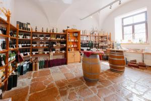 a room with wooden barrels and shelves of wine bottles at Augustiner-Chorherrenstift Reichersberg in Reichersberg