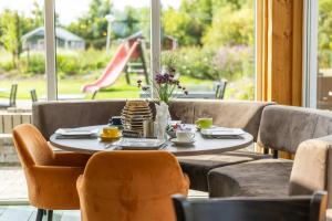 a table with cups and saucers on top of it at Waddenlodge Exclusive in Harlingen