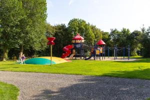 a park with a playground with a slide at Waddenlodge Exclusive in Harlingen