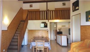 a room with a staircase with a table and a couch at LES BALCONS DE LA CHIUSA in Vico