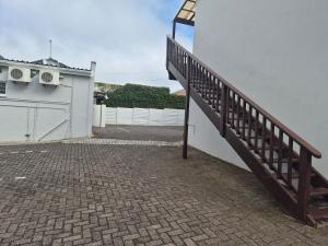a stairway leading up to a white building at Deck Room with Neighborhood view in Bunkers Hill