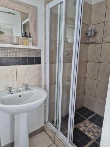 a bathroom with a sink and a shower at Deck Room with Neighborhood view in Bunkers Hill