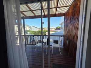 a balcony with a table and chairs on a deck at Deck Room with Neighborhood view in Bunkers Hill
