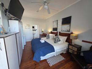 a bedroom with a bed and a flat screen tv at Deck Room with Neighborhood view in Bunkers Hill