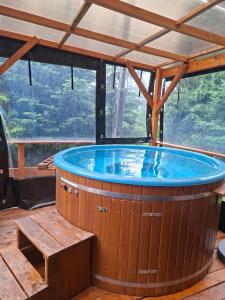 a jacuzzi tub in a building with a view at Osada Pod Turbaczem in Nowy Targ