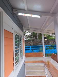 a porch of a house with wooden stairs at Breeze Homestay in Nong Khai
