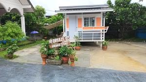 a small house with a sign in front of it at Breeze Homestay in Nong Khai +8 photos
