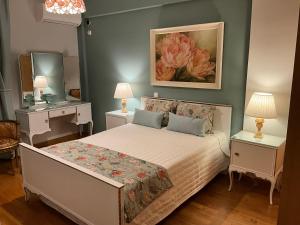 a bedroom with a bed with two tables and a mirror at VERA’S APARTMENT in Markopoulo +30 photos