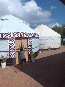 a person standing in front of a door in a yurt at Madriel Eko Retreat in Bokonbayevo