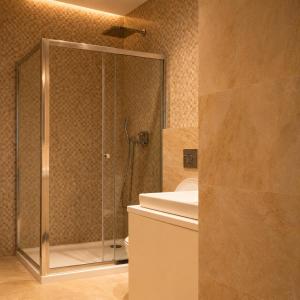 a bathroom with a shower with a toilet and a sink at Vinyl & Wine Retreat by THE HOUSE Experience Collection in Škaljari