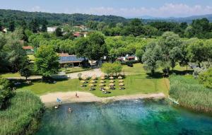 an aerial view of a park with a group of tables at Camping Rose in Dormelletto