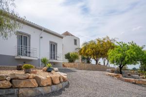 a large white house with a stone driveway at Dois Moinhos Do Vento, Santo Estevão in Santo Estêvão
