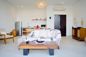 a living room with a couch and a table at Villa Mercure. Private villa. 2 en-suite bedrooms. in Amed