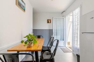 a dining room with a wooden table and chairs at 11 - Le Rossignol - Village vacances in Maché +37 photos