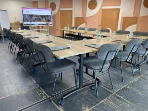 a large conference room with a long table and chairs at The Originals City, Ax Hotel, La Châtaigneraie in La Châtaigneraie +54 photos