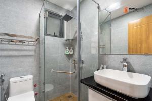 a bathroom with a sink and a shower and a toilet at HongHome Nguyễn Cửu Vân in Ho Chi Minh City +93 photos