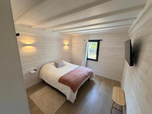 a small bedroom with a bed and a television at Chez Mémé Cécile in Montluçon