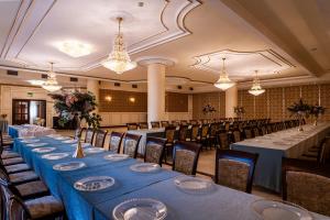 a banquet hall with long tables and chairs at Hotel - Dworek Tryumf in Księżyno