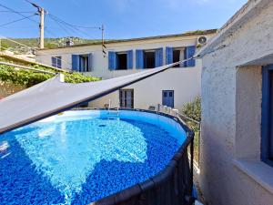 a swimming pool in front of a house at Mediterranean House with private garden near Crikvenica in Drivenik