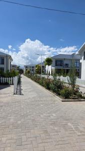 a brick walkway in front of some buildings at Cottage in Bosteri