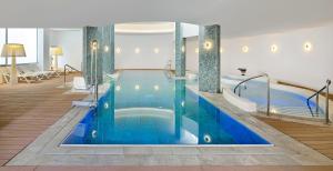 a large swimming pool in a hotel room at SOL by Meliá Torremolinos Don Marco - Adults Recommended in Torremolinos