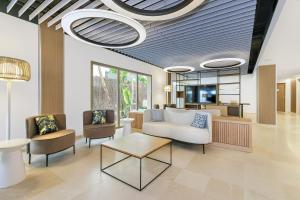 a lobby with a couch and two chairs and a table at SOL by Meliá Torremolinos Don Marco - Adults Recommended in Torremolinos