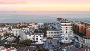 an aerial view of a city with buildings and the ocean at SOL by Meliá Torremolinos Don Marco - Adults Recommended in Torremolinos +36 photos
