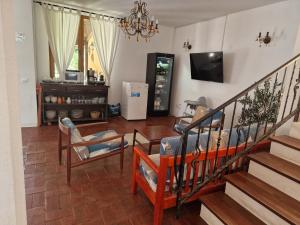 a living room with a staircase and a tv at Vila Eclipse Mamaia nord in Mamaia Sat/Năvodari