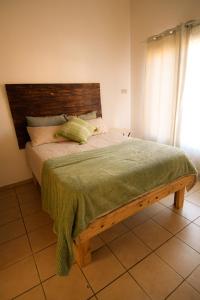 a bed with a wooden headboard in a bedroom at Melvillas in Louis Trichardt