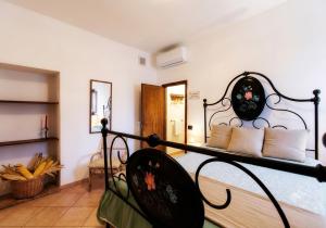 a bedroom with a wrought iron bed in a room at I Castagnini in Montecatini Val di Cecina