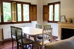 a dining room with a table and chairs and a fireplace at Los Jazmines de la Vega in La Vega +27 photos