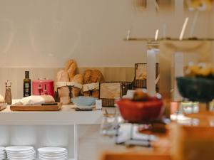 a kitchen with a counter with bread and other items at Sercotel Valencia Ruzafa in Valencia