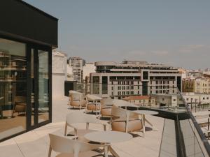 a group of chairs and tables on a balcony at Sercotel Valencia Ruzafa in Valencia