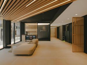 an office lobby with a couch and a table at Sercotel Valencia Ruzafa in Valencia