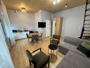 a living room with a couch and a table and chairs at Apartament Zbąszynek in Zbąszynek