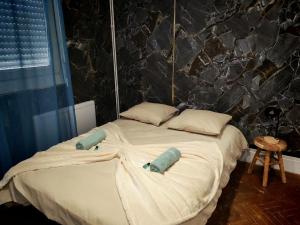 a bed with two pillows on it in a bedroom at Perle Centers in Dunkerque